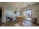 Bright dining area with table set, light fixture, and sliding glass door access to the patio at 11101 E Abilene Ave, Mesa, AZ 85208