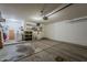 Large garage with concrete flooring, a roll-up door, and equipped with a washer and dryer at 11101 E Abilene Ave, Mesa, AZ 85208