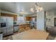 Eat in kitchen featuring stainless steel appliances and ample wood cabinetry at 11101 E Abilene Ave, Mesa, AZ 85208