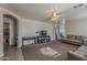 Spacious living room with plush carpet, ceiling fan, and neutral paint palette at 11101 E Abilene Ave, Mesa, AZ 85208