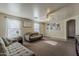 Comfortable living room with large sofas, natural light, and decorative wall art at 11101 E Abilene Ave, Mesa, AZ 85208