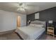 This bedroom is spacious with an accent wall, carpet, and a ceiling fan at 11101 E Abilene Ave, Mesa, AZ 85208