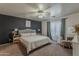This spacious bedroom features a ceiling fan, a neutral color scheme, and large windows at 11101 E Abilene Ave, Mesa, AZ 85208