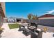 Inviting backyard with patio furniture, turf, gravel, block wall, and storage shed at 11450 E Elton Ave, Mesa, AZ 85208