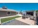 Wide backyard with artificial turf, storage shed, patio furniture, and gravel at 11450 E Elton Ave, Mesa, AZ 85208