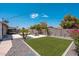 This backyard features gravel, artificial grass, and a concrete patio with a picnic table, perfect for outdoor entertaining at 11450 E Elton Ave, Mesa, AZ 85208