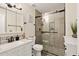 Modern bathroom features a glass enclosed shower with decorative tile and a white vanity with black fixtures at 11450 E Elton Ave, Mesa, AZ 85208