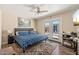 Serene bedroom with wood floors, a ceiling fan, and French doors leading to an outdoor space at 11450 E Elton Ave, Mesa, AZ 85208