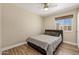 Neutral bedroom features hardwood floors, a double bed, and a window with natural light at 11450 E Elton Ave, Mesa, AZ 85208