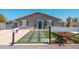 Charming single-story home with a blue front door, desert landscaping and gray exterior paint at 11450 E Elton Ave, Mesa, AZ 85208