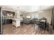Open-concept living space with modern furnishings, seamlessly connecting the kitchen, dining, and living areas at 11450 E Elton Ave, Mesa, AZ 85208