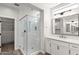 Bathroom features a glass shower, white cabinets, and modern vanity at 129 E Los Andes Ln, Queen Creek, AZ 85140