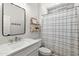 Bathroom featuring a vanity, mirror, and shower with decorative tile accent at 129 E Los Andes Ln, Queen Creek, AZ 85140