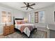 Cozy bedroom showcasing a comfortable bed, stylish decor, and natural light from the windows at 129 E Los Andes Ln, Queen Creek, AZ 85140