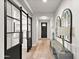 Hallway featuring hardwood flooring, modern lighting and shelving at 129 E Los Andes Ln, Queen Creek, AZ 85140