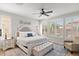 Inviting main bedroom with hardwood flooring, plantation shutters and ceiling fan at 129 E Los Andes Ln, Queen Creek, AZ 85140
