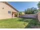 Lush backyard with well-maintained lawn, a covered patio, and a built-in barbecue area at 12910 W Glenrosa Dr, Litchfield Park, AZ 85340