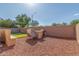Backyard featuring a built-in barbeque, bench seating, and low-maintenance gravel landscaping at 12910 W Glenrosa Dr, Litchfield Park, AZ 85340