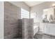 This bathroom features tiled walls, a glass block window, and a separate tub and shower at 12910 W Glenrosa Dr, Litchfield Park, AZ 85340
