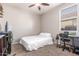 Neutral bedroom with white bedding, desk and blinds at 12910 W Glenrosa Dr, Litchfield Park, AZ 85340