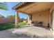 Relaxing covered patio featuring outdoor seating, a lush lawn, and access to the grill at 12910 W Glenrosa Dr, Litchfield Park, AZ 85340