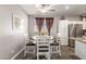 Charming dining area with a round table, seating for four, and natural light from the window at 12910 W Glenrosa Dr, Litchfield Park, AZ 85340