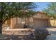Single-story home with a tile roof, neutral stucco exterior, and a two-car garage at 12910 W Glenrosa Dr, Litchfield Park, AZ 85340