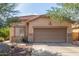 Single-story home with a tile roof, neutral stucco exterior, and a two-car garage at 12910 W Glenrosa Dr, Litchfield Park, AZ 85340