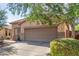 Single-story home with a tile roof, neutral stucco exterior, and a two-car garage at 12910 W Glenrosa Dr, Litchfield Park, AZ 85340