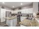 Modern kitchen with stainless steel appliances, granite countertops, and a functional layout for cooking and dining at 12910 W Glenrosa Dr, Litchfield Park, AZ 85340