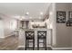 Open-concept kitchen featuring a breakfast bar, granite countertops, and seamless flow to the dining area at 12910 W Glenrosa Dr, Litchfield Park, AZ 85340