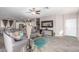 Stylish living room featuring plank floors, a ceiling fan, and a view into the kitchen at 12910 W Glenrosa Dr, Litchfield Park, AZ 85340