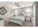 Serene main bedroom with a tufted headboard, ceiling fan, and ample natural light from the windows at 12910 W Glenrosa Dr, Litchfield Park, AZ 85340