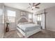 Comfortable main bedroom with ceiling fan, sliding barn door, and bright natural light at 12910 W Glenrosa Dr, Litchfield Park, AZ 85340