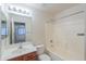 Bathroom with tub and shower, a vanity with storage, and tiled walls for easy maintenance at 1336 E Laurel Pl, Casa Grande, AZ 85122