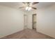 Spacious bedroom featuring carpet flooring, ceiling fan, and access to a closet for ample storage at 1336 E Laurel Pl, Casa Grande, AZ 85122
