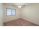 Cozy bedroom with carpet flooring, ceiling fan, and a window for natural light at 1336 E Laurel Pl, Casa Grande, AZ 85122