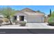 Inviting single-story home with a two-car garage, desert landscaping, and a charming covered porch at 1336 E Laurel Pl, Casa Grande, AZ 85122