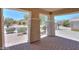 Charming covered front porch showcasing brick flooring and neighborhood views at 1336 E Laurel Pl, Casa Grande, AZ 85122