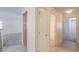 Hallway with a storage cabinet that provides access to a bathroom and leads to another room at 1336 E Laurel Pl, Casa Grande, AZ 85122