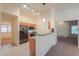 Modern kitchen with stainless steel appliances, wood cabinets, and an adjacent breakfast bar at 1336 E Laurel Pl, Casa Grande, AZ 85122