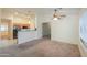 Inviting living room with a ceiling fan, open to the kitchen and dining area, filled with natural light at 1336 E Laurel Pl, Casa Grande, AZ 85122