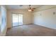 Bright living room with sliding glass doors to the patio, a ceiling fan, and speakers at 1336 E Laurel Pl, Casa Grande, AZ 85122