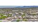 Charming neighborhood featuring tile roofs, mature trees, and mountain views in the distance at 1409 E Goldenrod St, Phoenix, AZ 85048