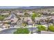 Aerial view of a well-maintained community, mature trees, and mountain views in the distance at 1409 E Goldenrod St, Phoenix, AZ 85048