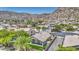 Aerial view of home with mountain backdrop showcasing covered patio and desert landscaping at 1409 E Goldenrod St, Phoenix, AZ 85048