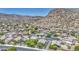 Panoramic aerial view of a Primary-planned community nestled amidst mountains, with well-maintained homes and streets at 1409 E Goldenrod St, Phoenix, AZ 85048