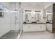 Modern bathroom featuring dual sinks, granite countertops, and walk-in shower at 1409 E Goldenrod St, Phoenix, AZ 85048