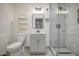 Bathroom featuring a glass shower, light fixtures, and a mirror at 1409 E Goldenrod St, Phoenix, AZ 85048
