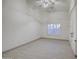 Bright bedroom features vaulted ceiling, tile floors, arched window, and ceiling fan at 1409 E Goldenrod St, Phoenix, AZ 85048